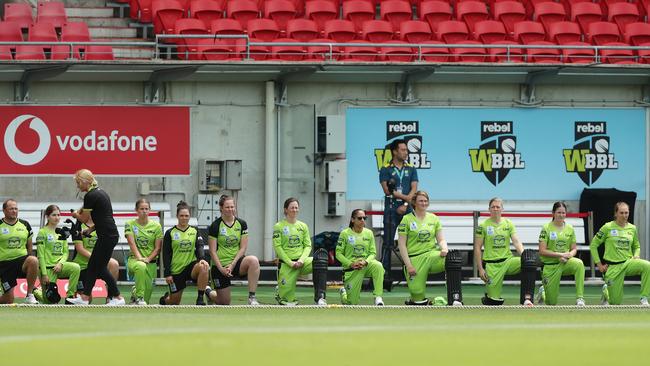 Thunder players take a knee at the start of the Women's Big Bash League WBBL match between the Sydney Thunder and the Adelaide Strikers. Picture: Mark Metcalfe/Getty Images