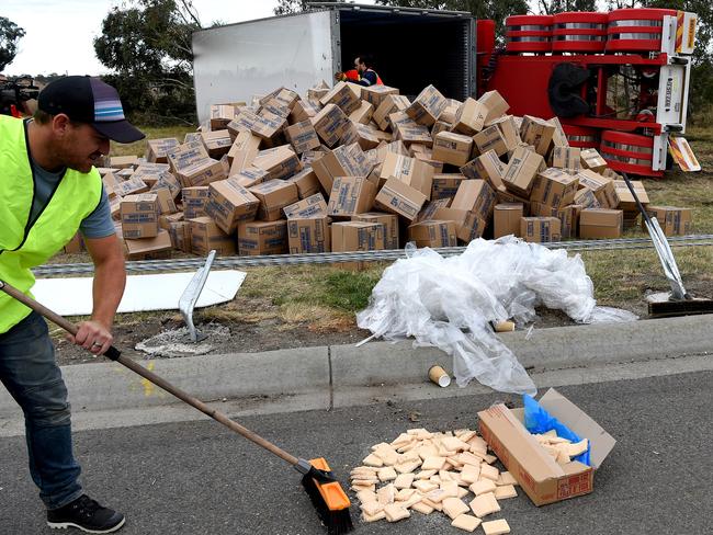 Cleaning up the nuggets.  Delays on Hume freeway after truck with chicken nuggetts rolls and blocks outbound lanes on Hume freeway from Western Ring Road to Cooper street, inbound traffic is clogged by rubbernecks, Lalor.  Picture: Nicole Garmston