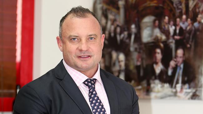 Criminal lawyer Campbell MacCallum, shadowed by a painting on his office wall that depicts gangsters popularised in movies — it was a gift from “one of my more gangster-type underworld clients”. Picture: Mike Batterham