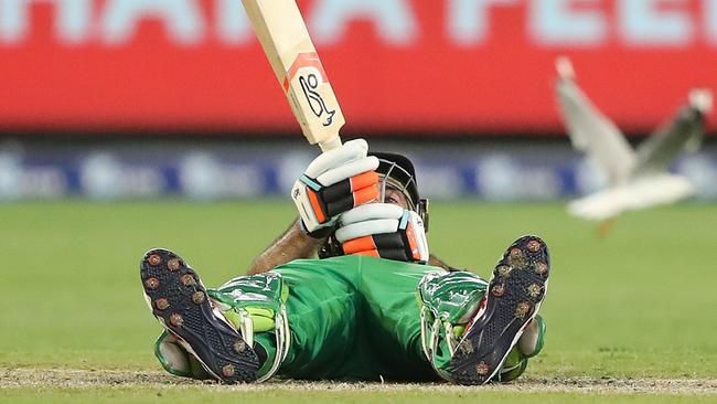 Glenn Maxwell of the Stars falls over as he plays a shot.