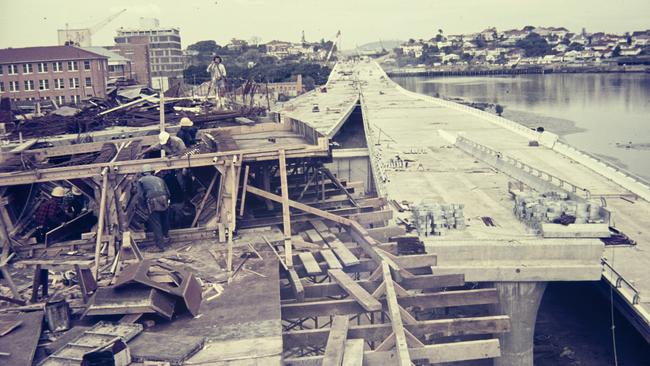 Labourers installing timber formwork for the road surfaces during construction of the Riverside Expressway, Brisbane. Photo: Gordon Foot/State Library of Queensland