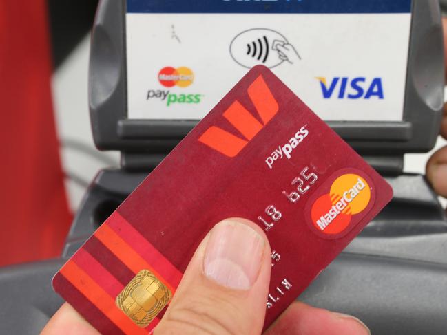 Stock image of a customer using a tap-and-go credit card in a store, Wednesday, Nov. 27, 2013. The Victorian police commissioner Lucinda Nolan says there has been a significant rise in credit card crime which has been attributed to the tap-and-go cards. (AAP Image/David Crosling) NO ARCHIVING