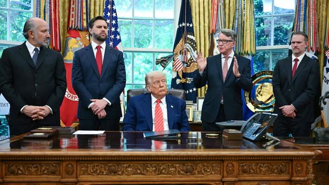 Donald Trump looks on as British ambassador Peter Mandelson (3R) speaks during a trade announcement in the Oval Office of the White House. Picture: AFP