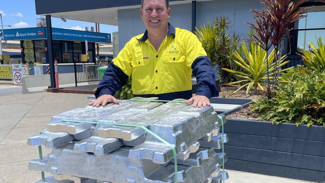 Gladstone Mayor Matt Burnett behind a stack of aluminum ingots at the Rio Tinto Boyne smelter.