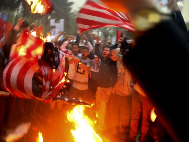 Iranian demonstrators burn US flags during a protest in front of the former US Embassy in response to Mr Trump’s decision to pull out of the nuclear deal. Picture: Vahid Salemi/AP