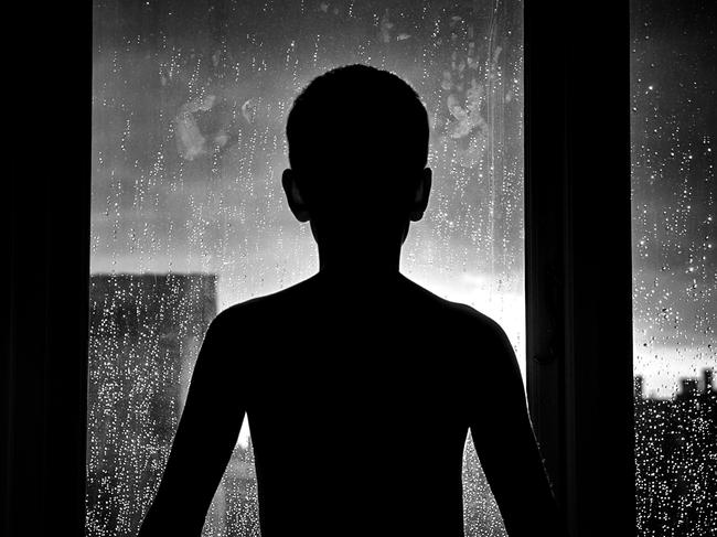 Silhouette of unrecognizable sad child. Generic iStock image.