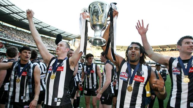 Collingwood players with the 2010 premiership cup.