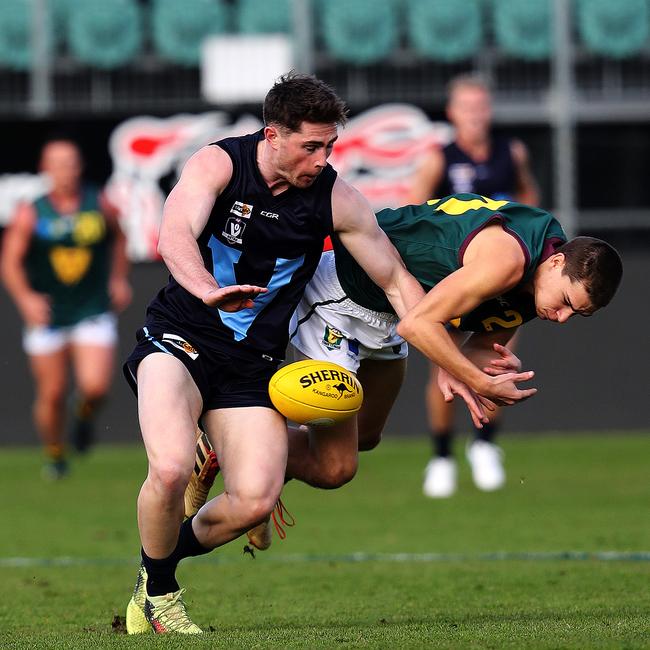 Tasmania Sherrin Egger and Vic Metro Jake Hobbs during the game against Vic Metro at UTAS Stadium. PICTURE CHRIS KIDD