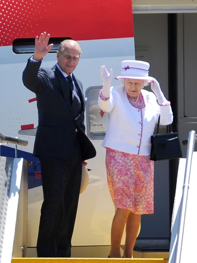 Britain's Queen Elizabeth II (R) and Prince Phillip (L) wave farewell as they depart Australia after a 10-day visit, in Perth in October, 2011. Picture: William West/AFP