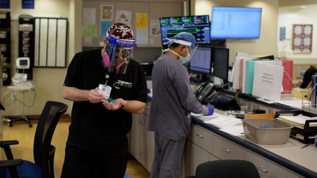 A doctor puts on hand sanitiser in the ER at Oakbend Medical Center in Richmond, Texas. One research team suggests the near-universal use of masks could save 40,000 lives between now and November. Picture: AFP