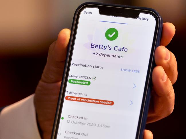 SYDNEY, AUSTRALIA - NewsWire Photos SEPTEMBER 22, 2021. Minister for Customer Service Victor Dominello pictured showing how the vaccine passport looks on a check in app (example test screen pictured) after a COVID-19 update press conference in St Leaonards.Picture: NCA NewsWire / Damian Shaw