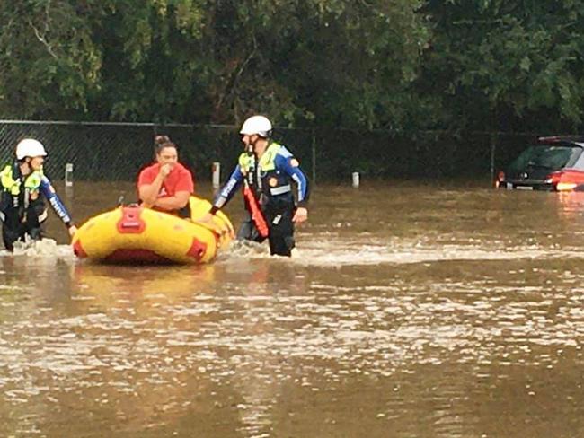 A woman is rescued from her car stuck in flood water. Picture: Central Coast Volunteer Rescue Association