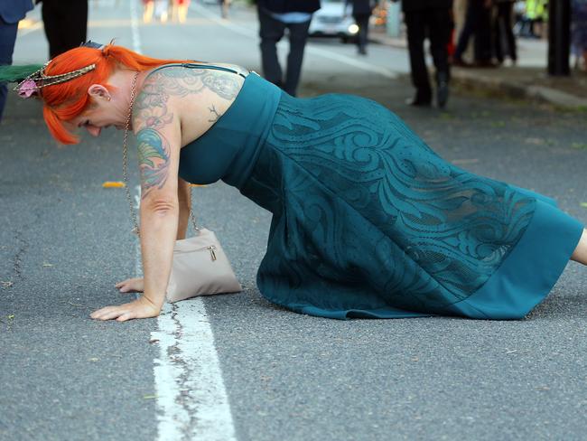 People leaving the Melbourne Cup Day at Eagle Farm. Picture: AAP/Richard Gosling