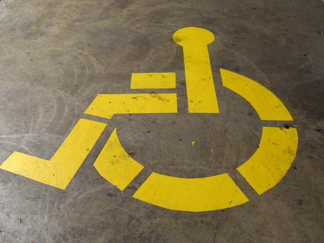 A disability carpark sign is seen at Parliament House in Canberra on Wednesday, April 27, 2016. (AAP Image/Mick Tsikas) NO ARCHIVING