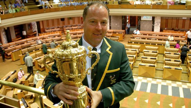 Victorious Springboks coach Jake White poses with the Rugby World Cup in 2007.