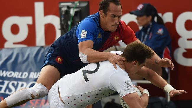 Alex Gray of England (R) tackled by Damien Cler of France in their quarterfinal on day two of the Men's 2016 USA Sevens Rugby Tournament match at the Sam Boyd Stadium in Las Vegas.