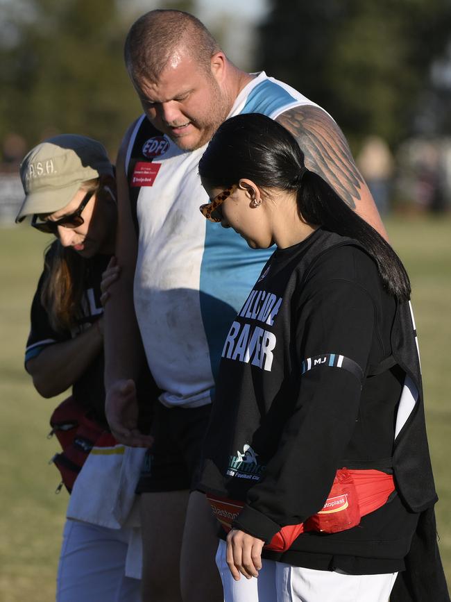 Hillside’s Josh Covelli is assisted off the ground. Picture: Andrew Batsch