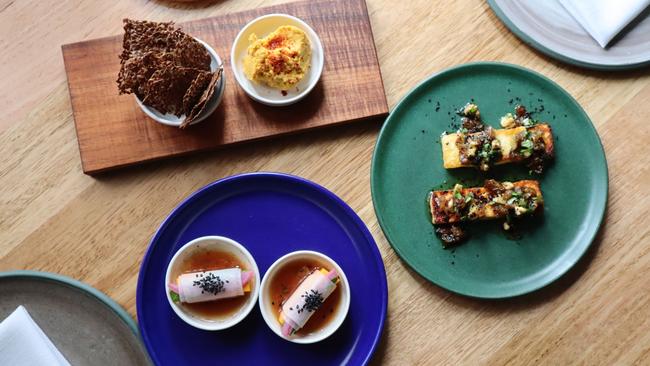 Flaxseed crisps with carrot hummus, haloumi and pumpkin tofu. Picture: Supplied