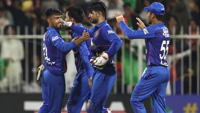 SHARJAH, UNITED ARAB EMIRATES - MARCH 18: Nangeyalia Kharote of Afghanistan celebratesCurtis Champer of Ireland  with teammates after dismissing  during the Men's Twenty20 International match between Afghanistan and Ireland on March 18, 2024 in Sharjah, United Arab Emirates. (Photo by Francois Nel/Getty Images)