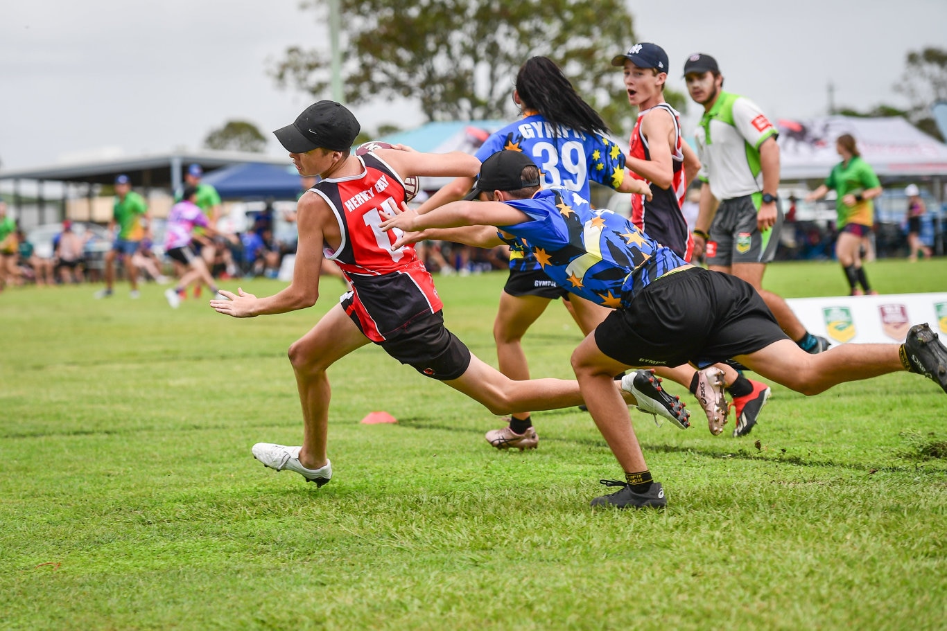 Hervey Bays Tom Hillhouse gets tagged by Gympies Samuel Hinds.