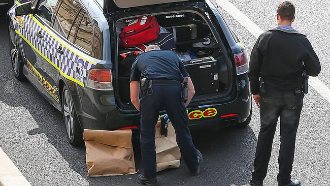 Police gather evidence at the scene yesterday. Picture: Ian Currie