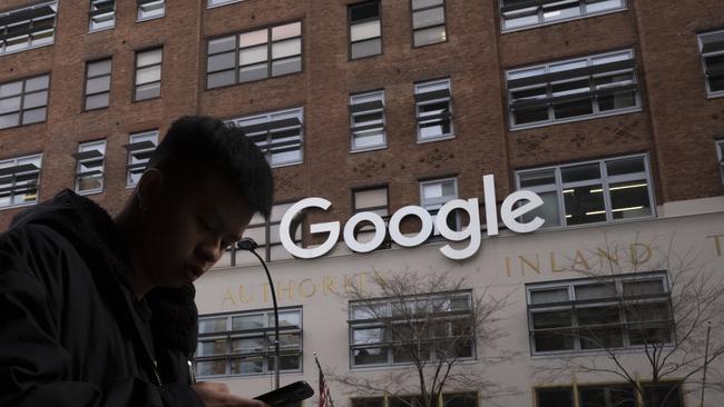 A man using a mobile phone walks past Google’s offices in New York. Picture: AP