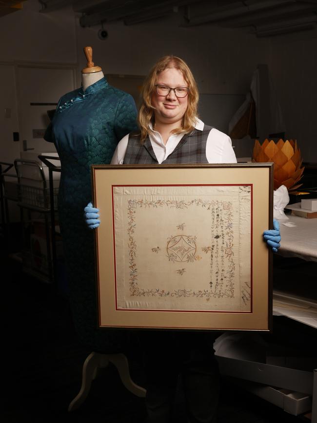 Isobel Andrewartha, senior curator of cultural heritage at TMAG, holding the handkerchief from 1909 with handwritten Chinese characters which belongs to Jan Everett and will feature in the Home: Here and Now exhibition. Picture: Nikki Davis-Jones