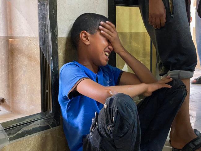 A Palestinian youth cries as he waits for news on a relative injured in Israeli strikes in Khan Yunis, at the Nasser hospital in the southern Gaza Strip. Picture: AFP