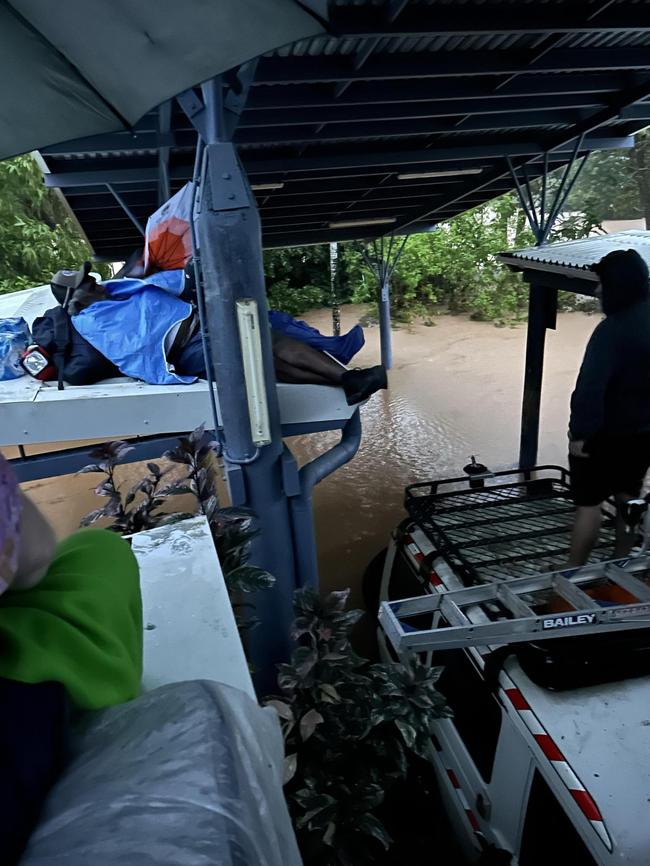 Residents, patients and nurses take refuge on the roof of the Wujal Wujal Primary Health Care Centre.