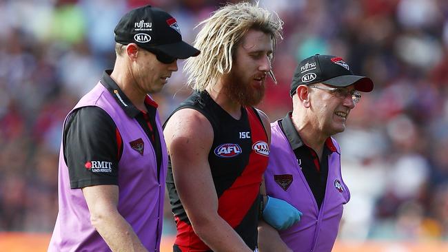 Dyson Heppell is helped from the field.