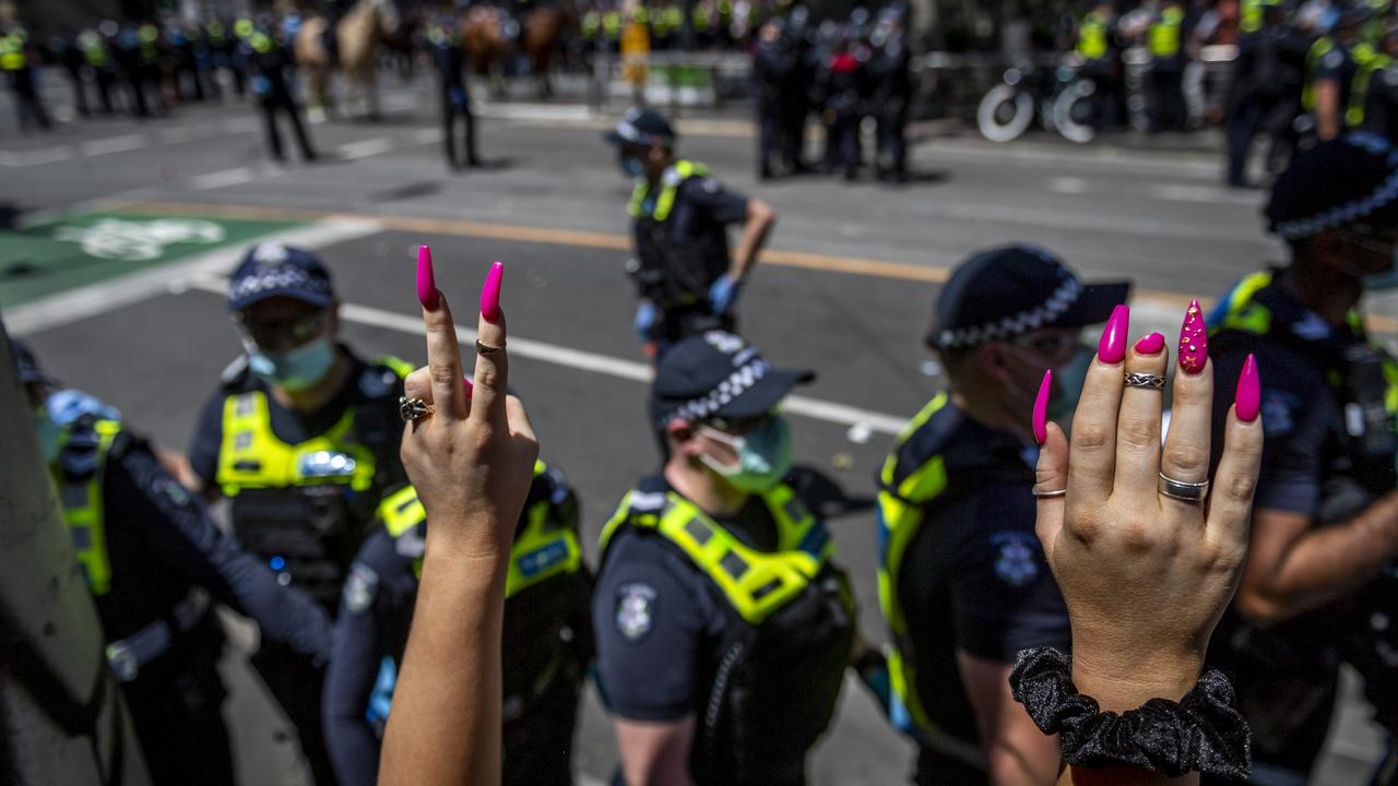 Police surround protesters near Parliament House on Melbourne Cup Day. Picture: Jake Nowakowski