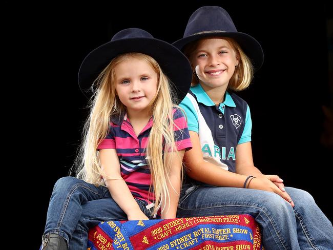 The Royal Agricultural Society of NSW announce that the 2021 Sydney Royal Easter Show will go ahead this year with Covid-19 restrictions in place including online ticket sales where show-goers will have to nominate a day to attend. L-R Emalee Cape 4 and Skye McKewin 9 with some throw rugs made from last years show ribbons that weren't used. 500 of the rugs will be sold to raise money for rural hospitals and buy equipment for kids wards. Picture: Toby Zerna