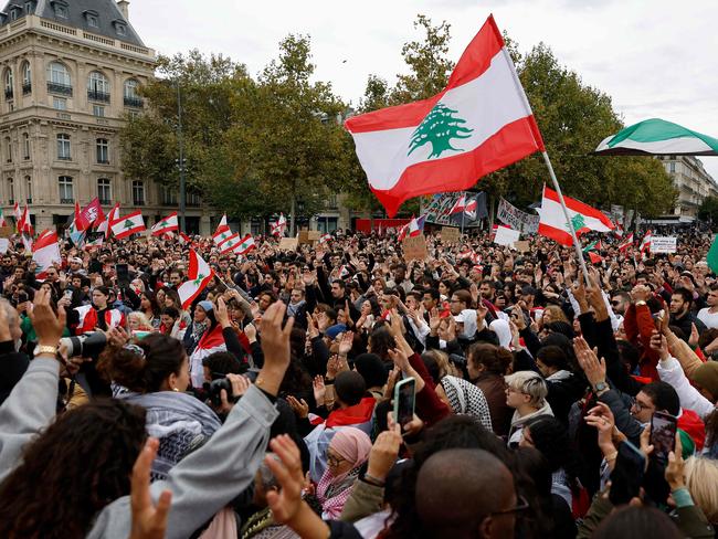 Protesters wave Lebanese flags during a demonstration on Place de la Republique, in Paris. Picture: AFP