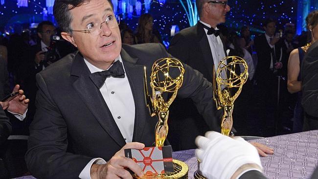 Stephen Colbert waits to get his name on his Emmy. Photo: Splash News