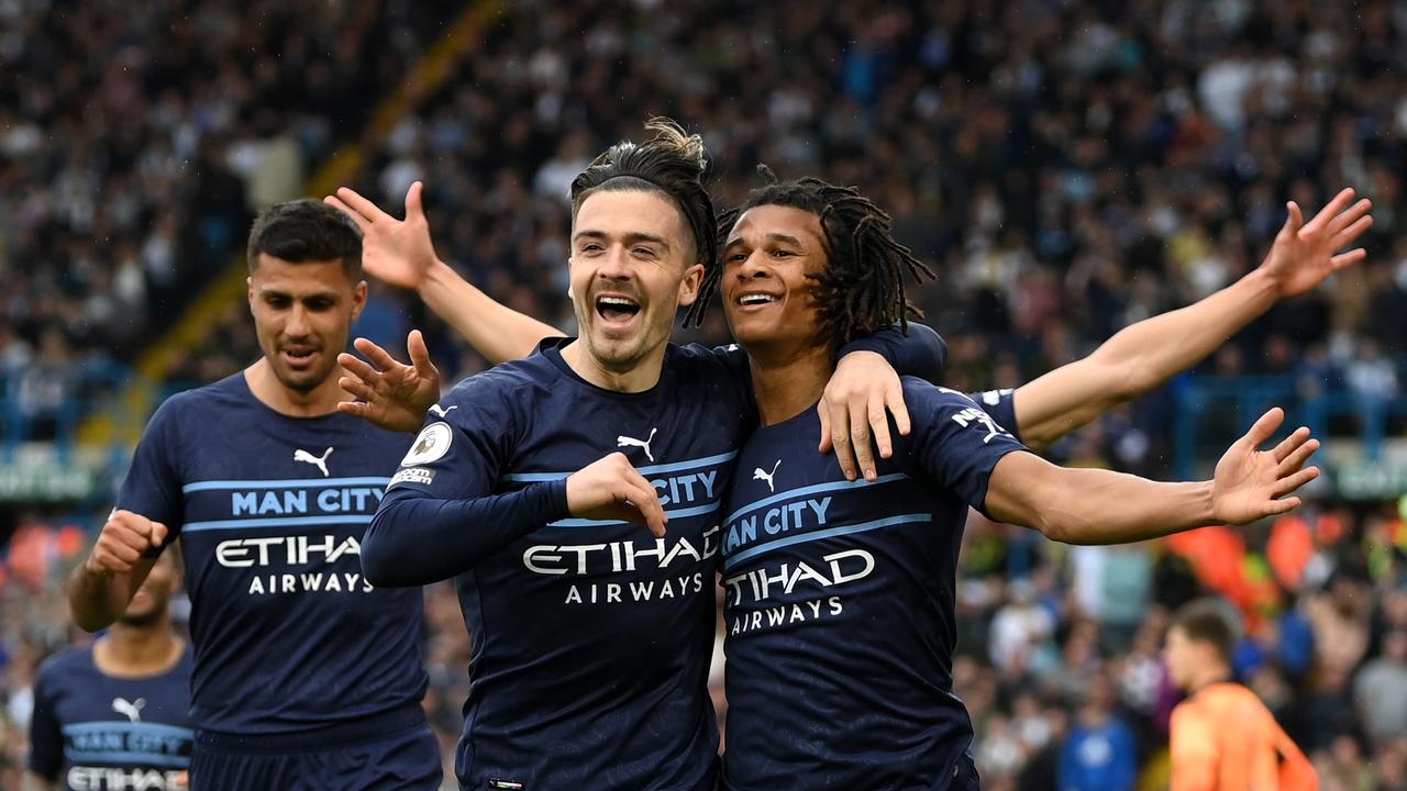 LEEDS, ENGLAND - APRIL 30: Nathan Ake of Manchester City celebrates with teammate Jack Grealish after scoring their sides second goal during the Premier League match between Leeds United and Manchester City at Elland Road on April 30, 2022 in Leeds, England. (Photo by Michael Regan/Getty Images)