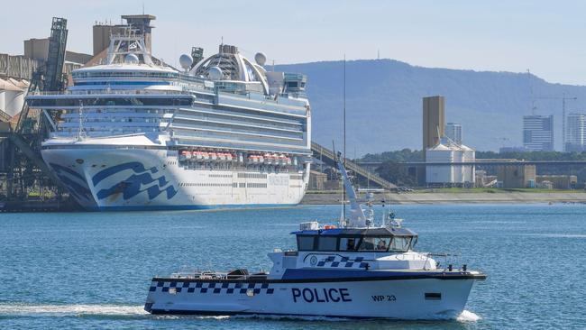 Water police patrol the contaminated cruise ship Ruby Princess while it berths in Port Kembla south of Sydney.