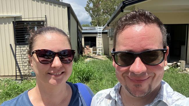 Holloways Beach residents Susie and Daniel Bateman lost their home during the December 2023 floods. The couple standing in front of their neighbour's home - where they spent a night on the roof awaiting rescue.