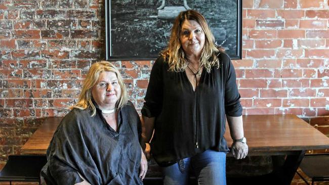 Sue and Carol Dingle (L-R) inside the new Dingles Caf & Bar, featuring a photo of their father Don Dingle. Picture: Dingles Cafe & Bar