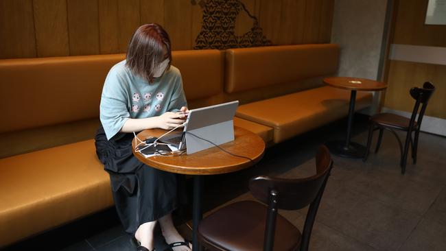 A woman works inside a cafe in Seoul. Picture: Getty Images