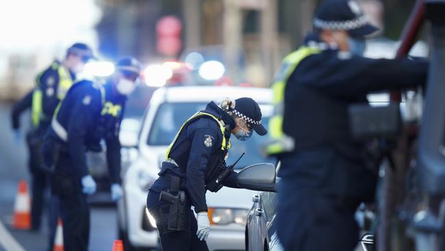 Police inspect licenses and question drivers at a suburban roadblock site in Broadmeadows. Picture: Getty