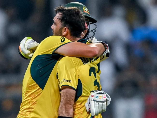 Australia's Glenn Maxwell celebrates with his captain Pat Cummins (L) after winning the 2023 ICC Men's Cricket World Cup one-day international (ODI) match between Australia and Afghanistan at the Wankhede Stadium in Mumbai on November 7, 2023. (Photo by INDRANIL MUKHERJEE / AFP) / -- IMAGE RESTRICTED TO EDITORIAL USE - STRICTLY NO COMMERCIAL USE --