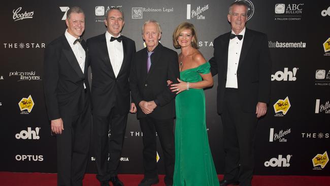 Lawyer Andrew Robinson(centre), pictured with Paul Hogan and wife Dominique Robinson (left) at a Tour De Cure Snow Ball. To his right is Bruno Maurel and Mark Beretta.