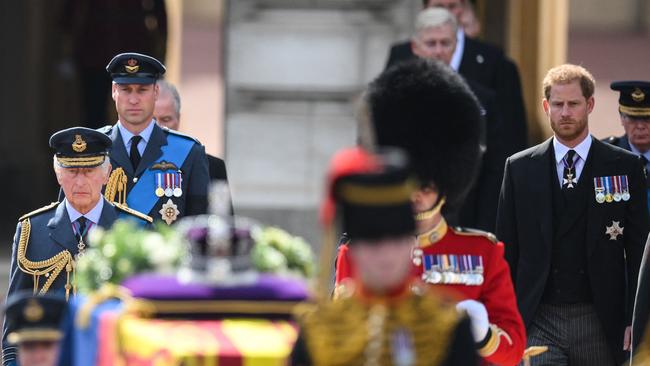 King Charles III, left, Prince William, second from left, and Prince Harry, right, walk behind the coffin of Queen Elizabeth II in London’s Pall Mall on Wednesday night (AEST). Picture: AFP