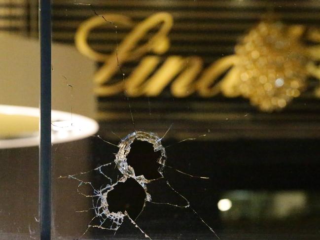 Vandals have pelted large rocks through the windows of the Lindt Cafe on Martin Place, Sydney CBD. Large railway ballast type rocks punched holes in the windows facing Martin Place. The cafe is still in the minds of Australians with the inquest unfolding in Sydney after the Siege which claimed the life of two innocent people. Glass and rocks could be seen inside the cafe on the floor. Pics Bill Hearne