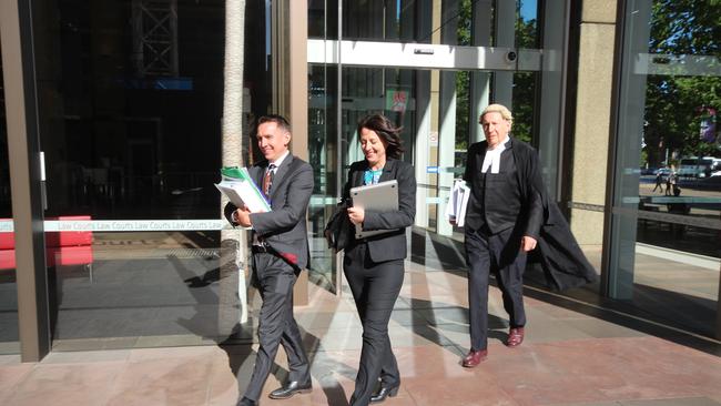 Esther Rockett (centre) with solicitor Stewart O'Connell and barrister Tom Molomby after the final hearing in the defamation case brought against her by Universal Medicine leader Serge Benhayon.