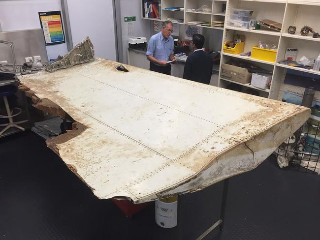 Malaysian and Australian investigators examining a piece of aircraft debris found on Pemba Island off the coast of Tanzania. Picture: ATSB