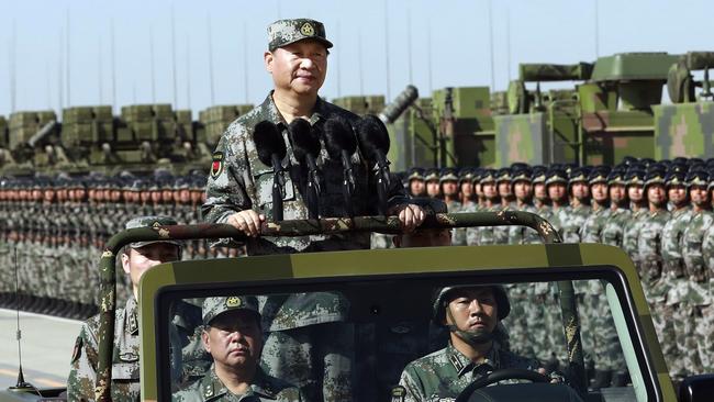 Chinese President Xi Jinping stands on a jeep as he inspects People's Liberation Army troops during a military parade in 2017.