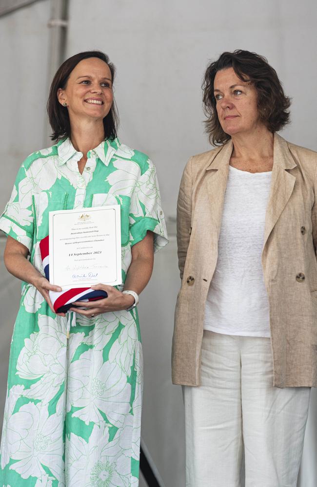 Emily MacManus left) and Dr Tarn McLean of The Lighthouse Toowoomba accept an Australian parliamentary flag sourced by Groom MP Garth Hamilton at Toowoomba Australia Day celebrations at Picnic Point, Sunday, January 26, 2025. Picture: Kevin Farmer