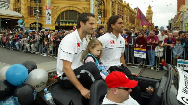 Gavin Wanganeen with daughter Mia and Peter Burgoyne during AFL Grand Final parade in 2004.