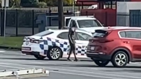 A man armed with a pole and machete has smashed the window of a car before driving off in a stolen patrol car. Picture: Supplied